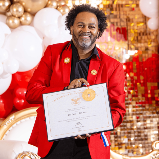 Pic of Dr. Eric holding certificate-min